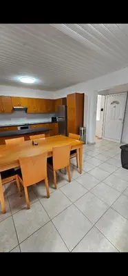 a dining room with a table and a kitchen at Luxury Apartment Ayia Napa Center in Ayia Napa