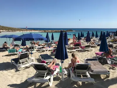 a group of people sitting in chairs on a beach at Luxury Apartment Ayia Napa Center in Ayia Napa