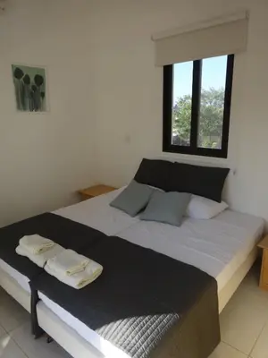 a bedroom with a large bed with two towels on it at Cy-Blue in Protaras