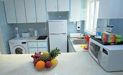 a kitchen with a bowl of fruit on a counter at Pieris Apartments in Ayia Napa