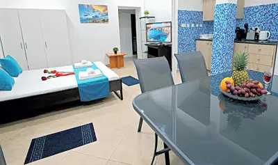 a living room with a table with a bowl of fruit on it at Pieris Apartments in Ayia Napa