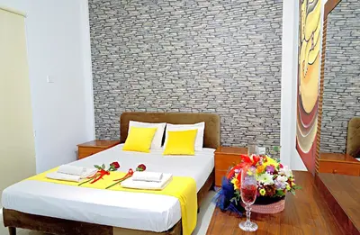 a bedroom with a bed with flowers on it at Pieris Apartments in Ayia Napa