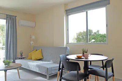 a living room with a couch and a table at Athena Holiday Homes in Limassol