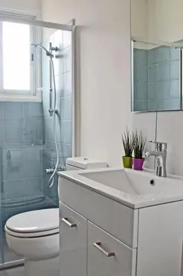 a bathroom with a sink and a toilet and a shower at Athena Holiday Homes in Limassol