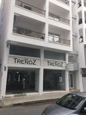a white apartment building with the rental sign on it at Nautilus Tourist Apartments in Larnaka