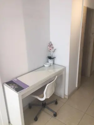 a white desk with a white chair in a room at Nautilus Tourist Apartments in Larnaka