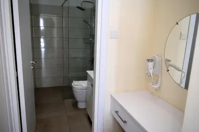 a bathroom with a shower and a sink and a toilet at Cross Road in Ayia Napa