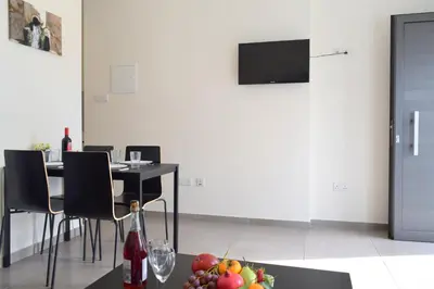 a dining room with a table with a bowl of fruit at Cross Road in Ayia Napa