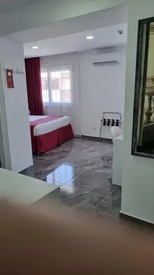 a hotel room with a bed and a mirror at Art & Wine Boutique Hotel in Larnaka
