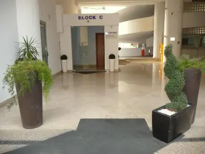 a lobby with potted plants in a building at T&E Apartment in Larnaka