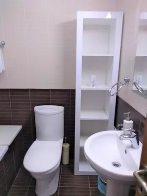 a bathroom with a toilet and a sink at T&E Apartment in Larnaka