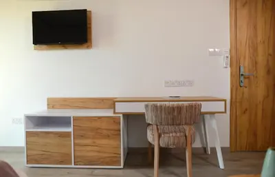 a desk with a chair and a television on a wall at Hypnos Boutique Hotel in Nicosia