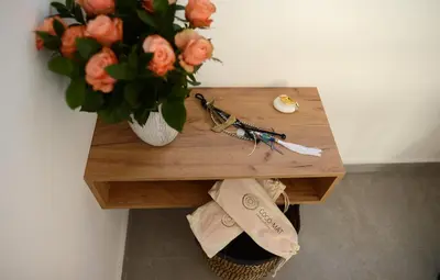 a wooden table with a vase of flowers on it at Hypnos Boutique Hotel in Nicosia