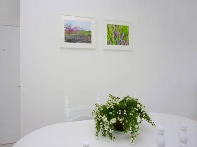 a white table with a potted plant on it at On The Beach Penthouse by TrulyCyprus in Limassol