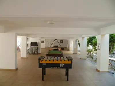 a living room with a pool table in the middle at Great Kings Resort Apartment 10 Block 19 in Protaras