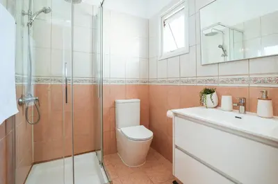 a bathroom with a toilet and a sink and a shower at Villa Celine in Protaras