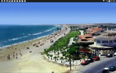 a view of a beach with people and the ocean at Panikos Beach Apartment I in Larnaka