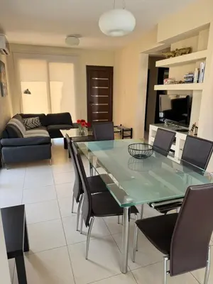 a living room with a glass table and chairs at Villa Sotmarie in Protaras