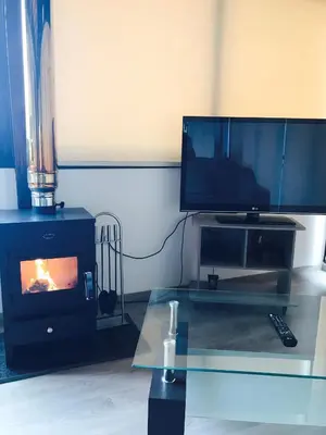 a living room with a tv and a fireplace at Xenios Guesthouse in Koilani