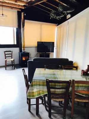 a living room with a table and chairs and a couch at Xenios Guesthouse in Koilani