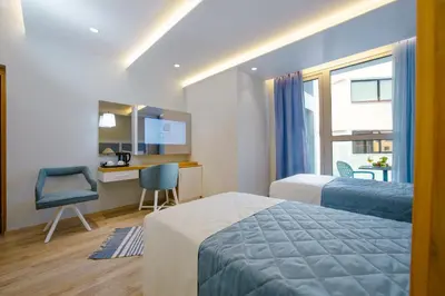 a hotel room with a bed and a desk and a chair at Qbic City Hotel in Larnaka
