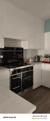 a kitchen with a black stove and white cabinets at Siamese Villa in Paralimni