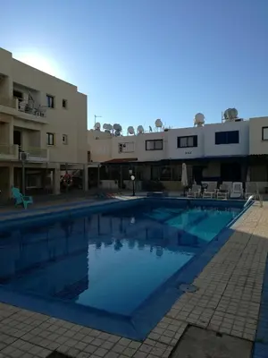a large swimming pool in front of a building at Siamese Villa in Paralimni