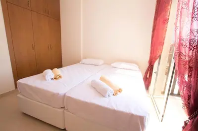 a bedroom with two beds with towels on them at Casa Di Kappari in Protaras