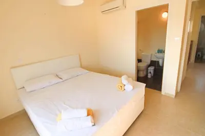 a bedroom with a white bed with towels on it at Casa Di Kappari in Protaras