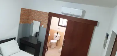 a room with a bathroom with a toilet and a door at Marina's Rooms in Larnaka