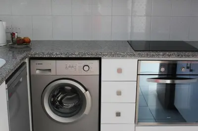 a kitchen with a washing machine and a counter at Olosuites in Limassol