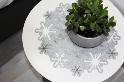 a potted plant on a white table with snowflakes at Olosuites in Limassol