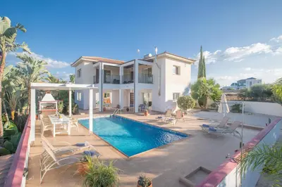 a villa with a swimming pool and a house at Villa Orka in Protaras