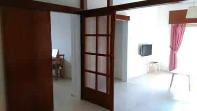 a living room with a door and a tv in a room at Modern City Center Apt in Larnaka