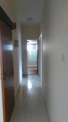 an empty hallway with a door and a room with a window at Modern City Center Apt in Larnaka