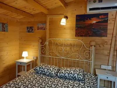 a bedroom with a bed in a wooden cabin at Cyprus Glamping Park in Ayios Theodhoros