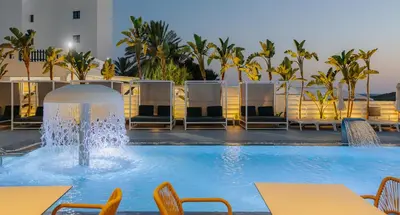 a pool with tables and chairs and a fountain at Tasia Maris Sands (Adults Only) in Ayia Napa