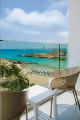 a balcony with a view of a beach at Tasia Maris Sands (Adults Only) in Ayia Napa