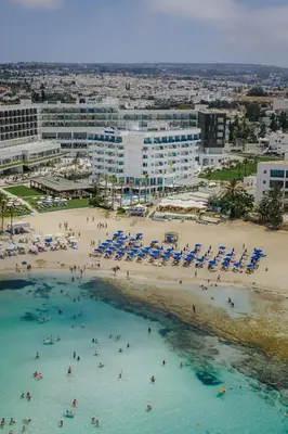 an aerial view of a beach with people and chairs at Tasia Maris Sands (Adults Only) in Ayia Napa