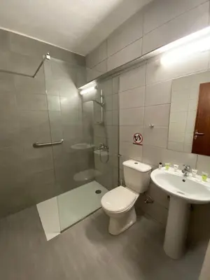 a bathroom with a toilet and a sink and a shower at Alexia Hotel Apartments in Ayia Napa