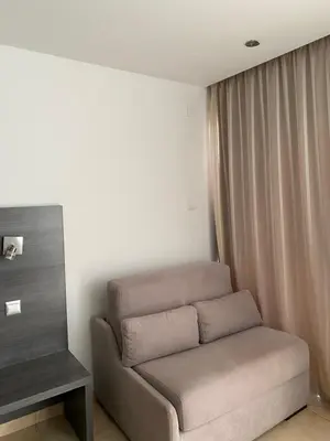 a living room with a couch and a table at Alexia Hotel Apartments in Ayia Napa