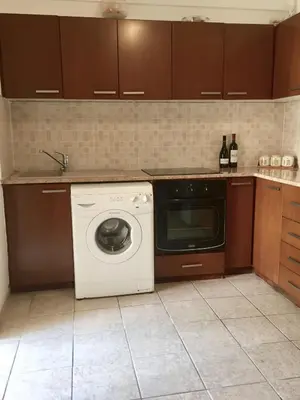 a kitchen with a washing machine and a sink at Sea View Apartment in Limassol