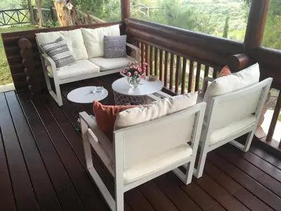 a porch with two chairs and a couch and a table at Anti Onirou in Flasou