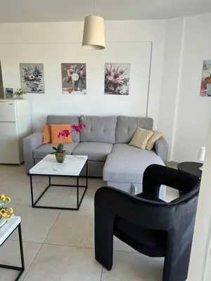 a living room with a couch and a table at Alex Beach Apartment 203 in Larnaka
