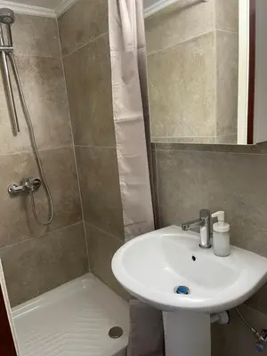 a bathroom with a sink and a shower at Alex Beach Apartment 33 in Larnaka