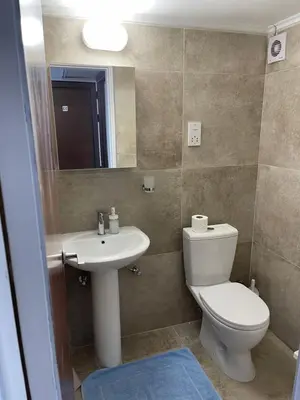 a bathroom with a toilet and a sink and a mirror at Alex Beach Apartment 33 in Larnaka