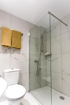 a bathroom with a toilet and a glass shower at Christofinia Hotel in Ayia Napa