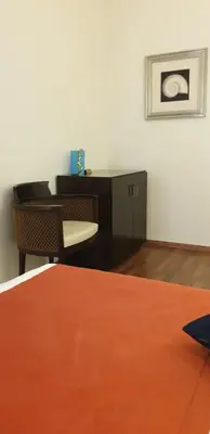 a room with a desk and a table and chairs at Castelli Hotel Nicosia in Nicosia