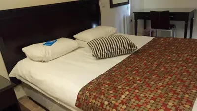 a bed with two pillows on top of it at Castelli Hotel Nicosia in Nicosia