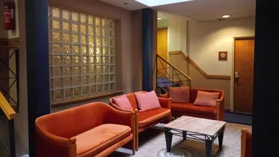 a living room with two chairs and a table at Castelli Hotel Nicosia in Nicosia